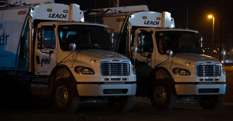 two large trucks in front of a building