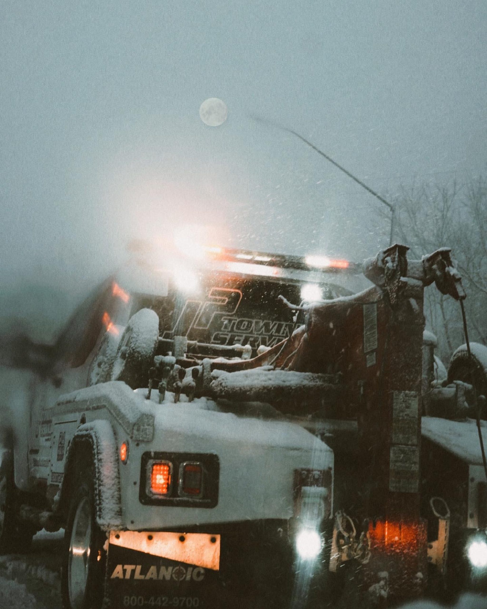 a tow truck on a snowy day