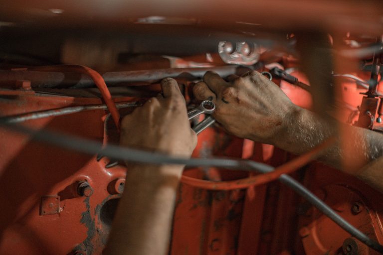 a mechanic's hands working on a truck or vehicle