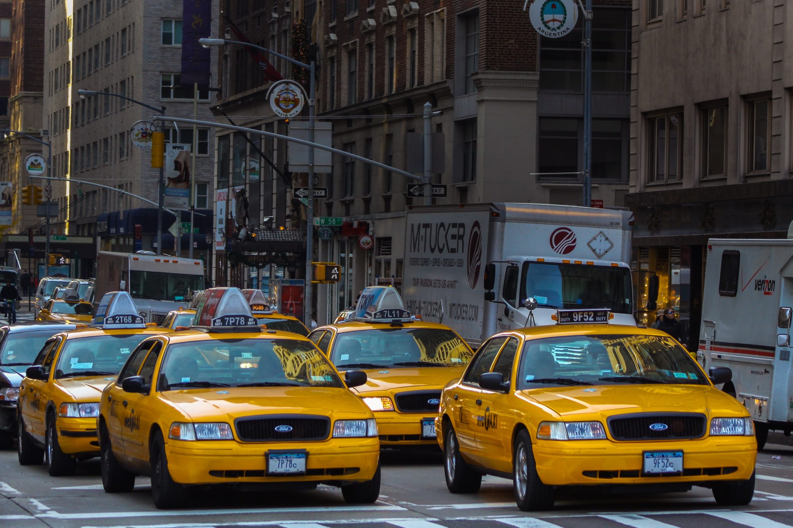 yellow taxis at traffic stop in a city