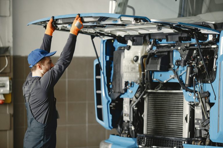 engine repair and diagnostics, mechanic inpsecting truck after gps fleet tracking reported insightful data